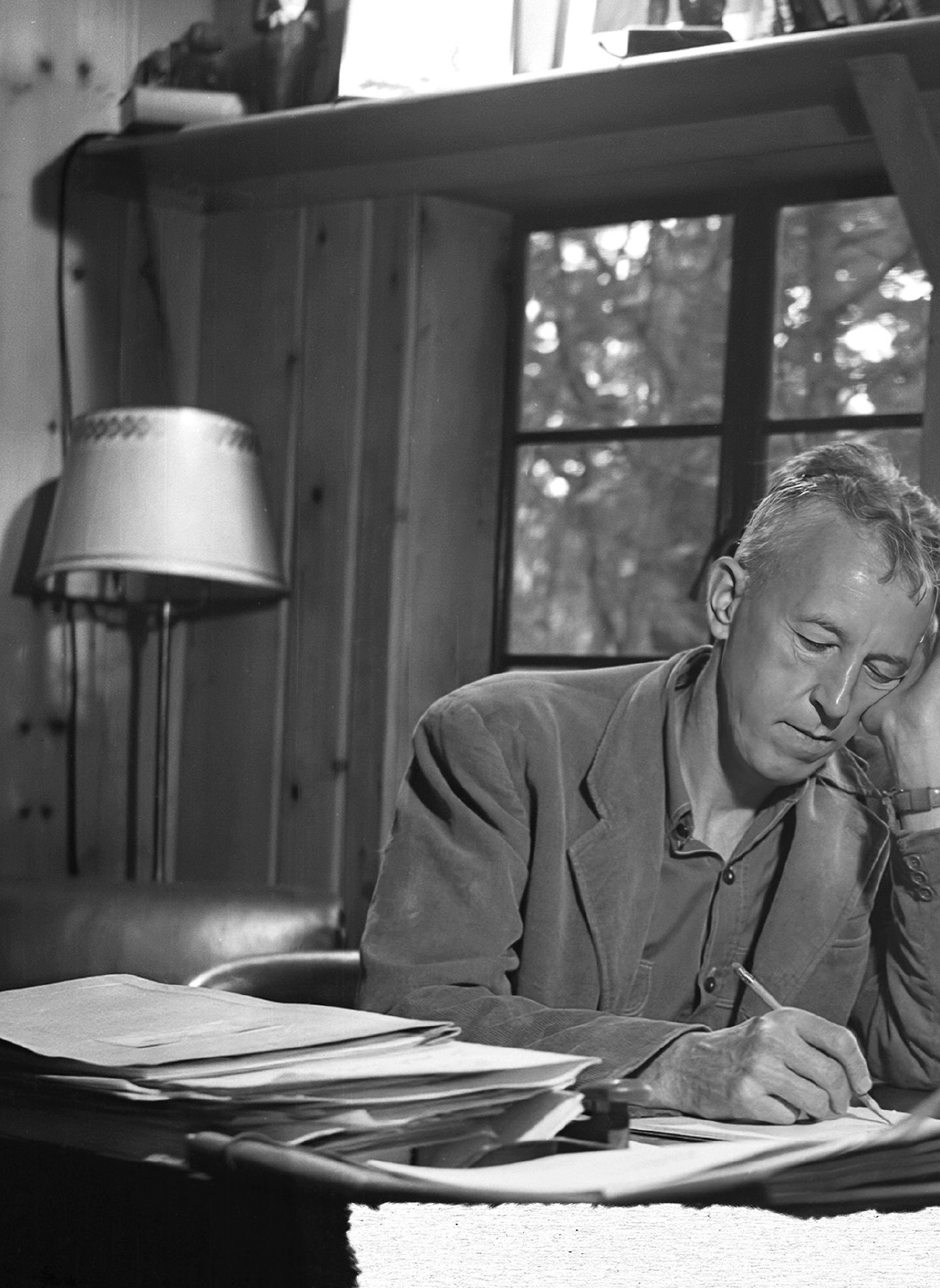 Bill Wilson writing at his desk